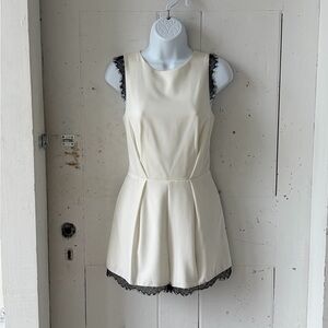 Necessary Objects Cream Sleeveless Romper with Black Lace Trim